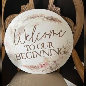 "Welcome to Our Beginning" round wedding sign